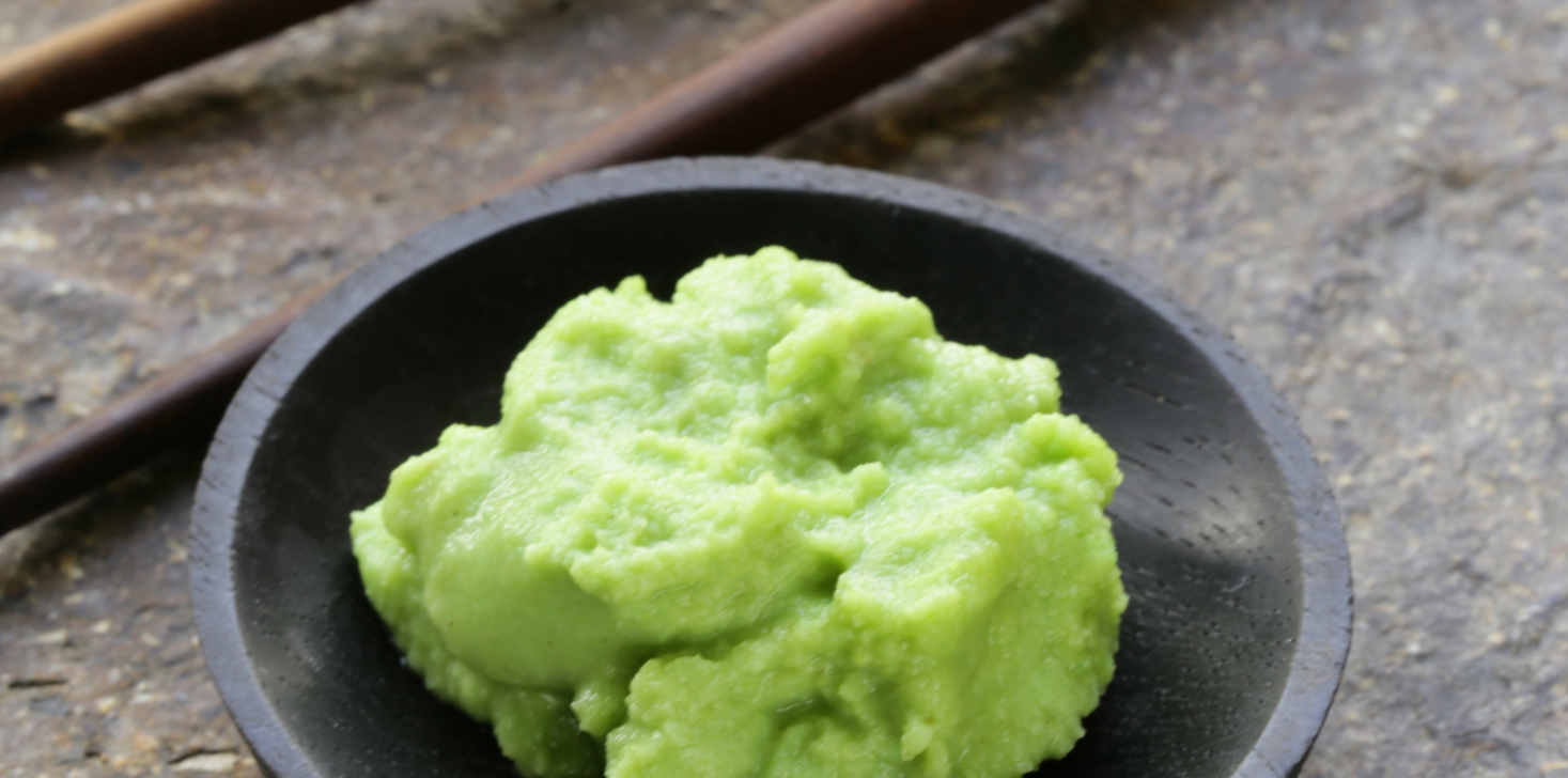 A little bowl with Japanese wasabi and chopsticks