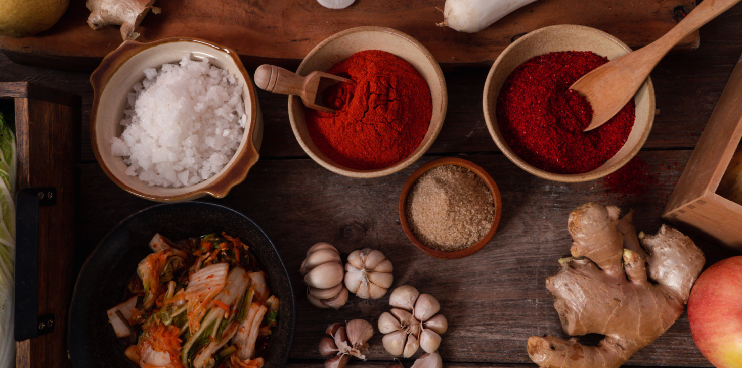 Fresh ingredients and vegetables Placed in the table For making Kimchi Which contains ingredients such as ginger, garlic, salt, onion, sugar, gochugaru (Korean chili). Kimchi is a healthy food.