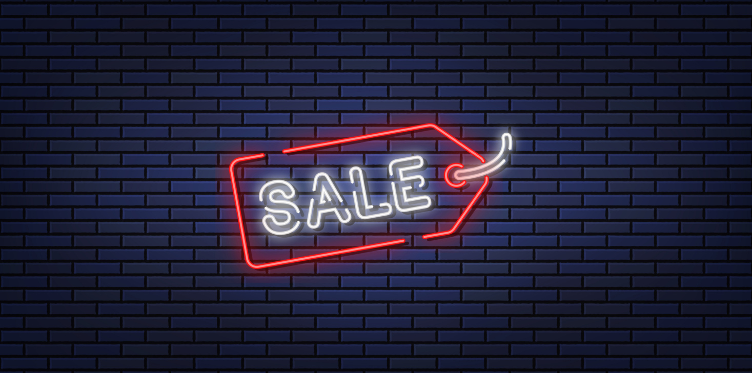 Neon illustration of sale on a brick wall